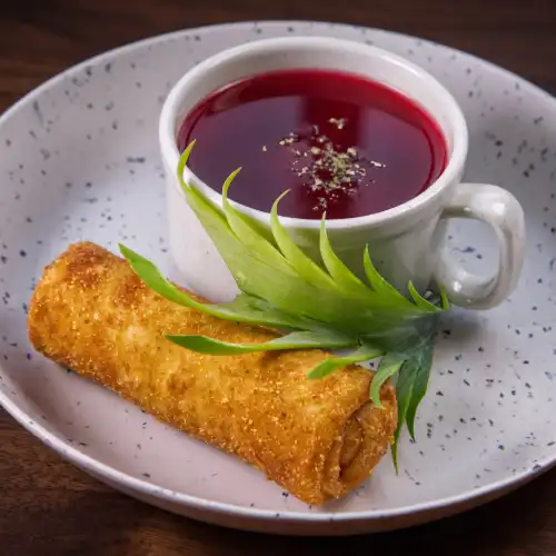 Traditional Polish red borscht served with a crispy krokiet at Restaurant Relax in Greenpoint, Brooklyn.