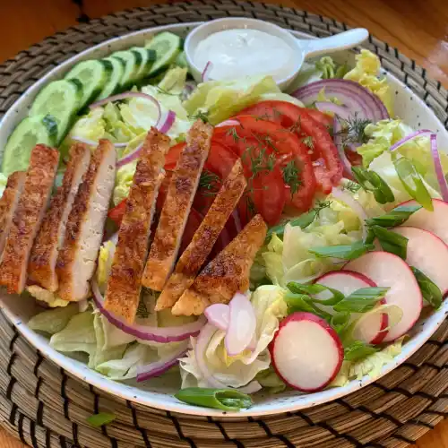 Relax House garden salad with sliced chicken, tomatoes, cucumber, radishes, red onion and herb dressing at Relax in Greenpoint
